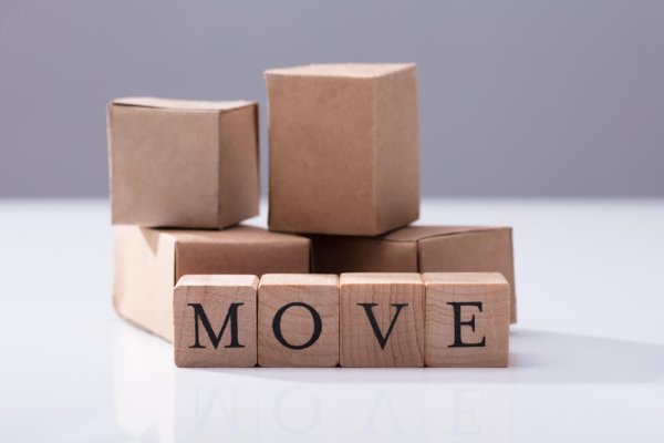 Close-up Of Move Text On Wooden Blocks In Front Of Cardboard Boxes