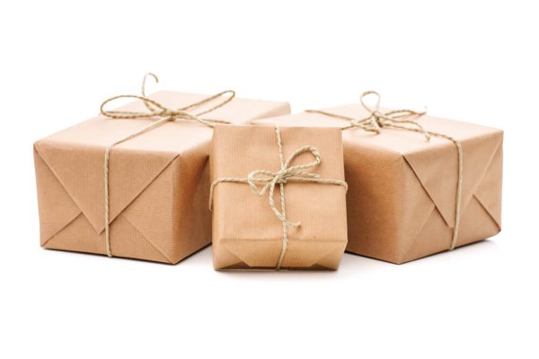 Group of parcels wrapped with brown paper and tied with string. Isolated on white background