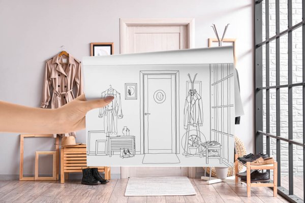 Designer holding sketchbook with drawing of new hallway interior